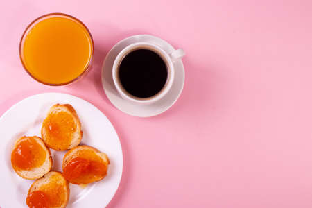 orange jam toasts and drink as breakfast conceptの写真素材