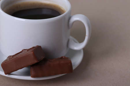 a white ceramic cup with black espresso, french croissant as breakfast or snack concept on rustic,...
