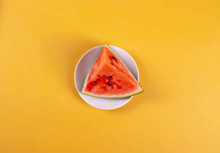 fresh and ripe watermelon on yellow background. minimalism styleの写真素材