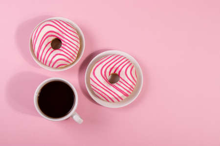 yummy sweet pink and white striped icing doughnutの写真素材