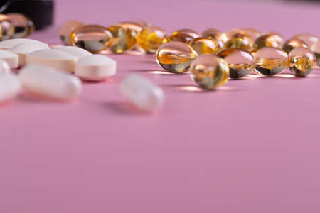 pills or food suplement on the pink backgroundの写真素材