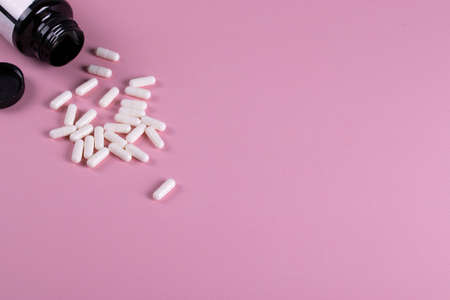 pills or food supplement on the pink backgroundの写真素材