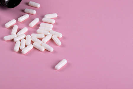 pills or food supplement on the pink background