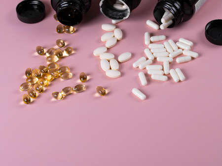 pills or food supplement on the pink backgroundの写真素材