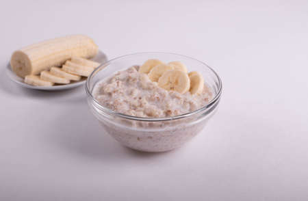 natural vegan oat granola cooked porridge and bananaの写真素材