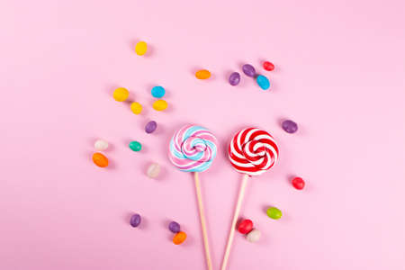 yummy sweet colour round lollipops on the pink background. minimalism style.の写真素材