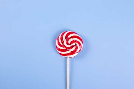 sweet yummy festive colorful lollipops on light blue background. copy space for text. minimalism styleの写真素材