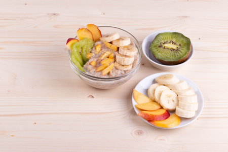a bowl of morning porridge and fruit as a healthy breakfast conceptの写真素材