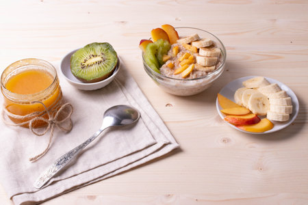 a bowl of morning porridge and fruit as a healthy breakfast conceptの写真素材