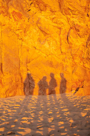 Travelers during golden sunset at Ursa beach, Portugal