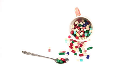 Drugs in glass and spoon, white background.のeditorial素材