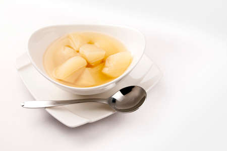 The white background presents white porcelain bowls and plates containing healthy and delicious...