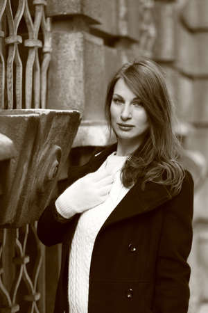 Beautiful brunette girl in front of a baroque palace in Vienna, Austriaの写真素材