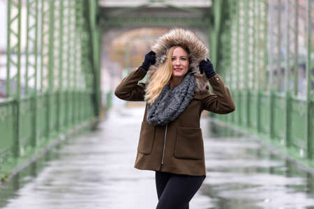 Beautiful blonde woman wearing winter jacketの写真素材