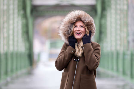 Beautiful blonde woman wearing winter jacketの写真素材