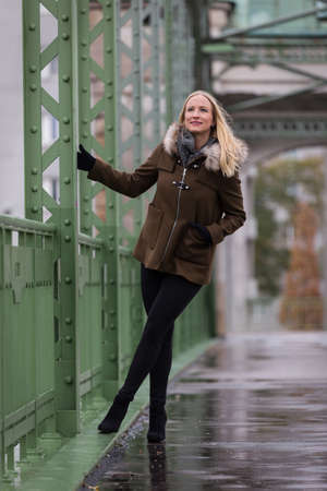 Beautiful blonde woman wearing winter jacketの写真素材