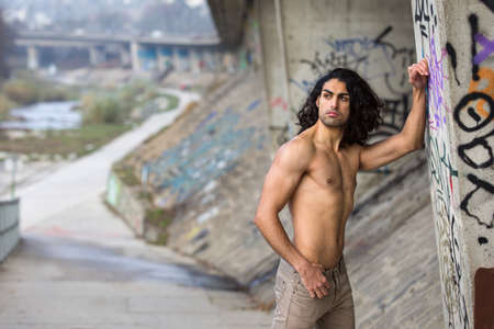 Muscular mediterranean man posing on streetの写真素材