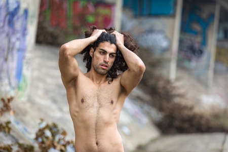 Muscular mediterranean man posing on streetの写真素材
