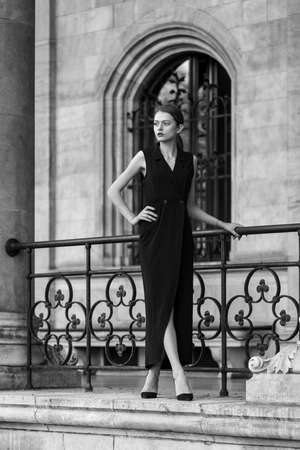 Young woman wearing long black dressの写真素材