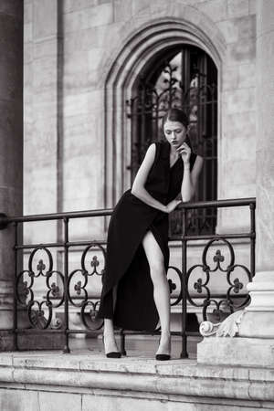 Young woman wearing long black dressの写真素材