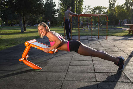 Muscular fitness girl doing pushupsの写真素材