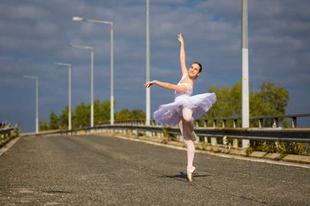 Dancing Ballerina wearing tutu on a highwayの写真素材