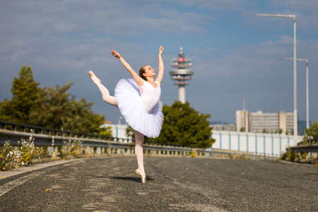 Dancing Ballerina wearing tutu on a highwayの写真素材