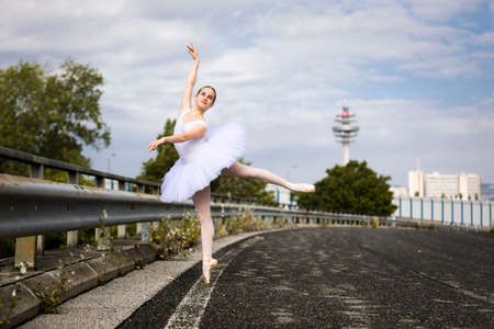 Dancing Ballerina wearing tutu on a highwayの写真素材