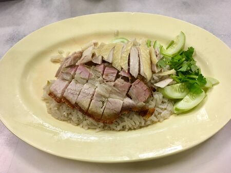 Asian gourmet Hainanese steamed chicken and crispy pork belly with riceの写真素材