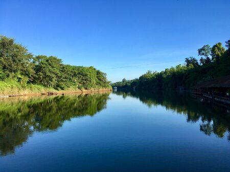 Symmetry, river tree and skyの写真素材