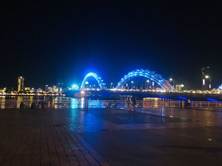 Dragon bridge landmark of Danang City, Vietnam on night scene, fully and tail view.の写真素材