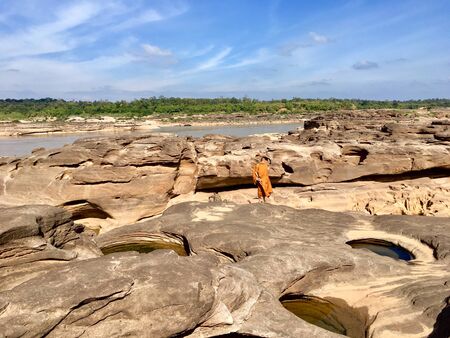 Stone scenery like grand canyon with a monk standing in Ubon Ratchathani of Thailand.の写真素材