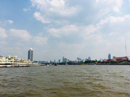 Scenery of Chao Phraya river with building, bridge and house river side, Bangkok, Thailandの写真素材