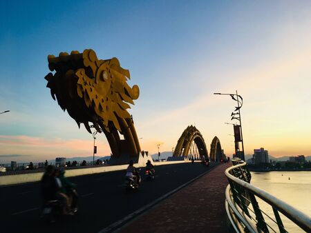 Dragon bridge cross the Han river, landmark of Danang City, Vietnam on sunset sceneの写真素材