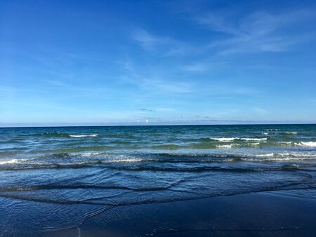 Scenery of empty sea beach sand and blue sky on summer sun dayの写真素材