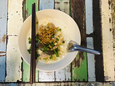 Vietnamese rice noodle soup topped with pork, blood pudding and fried garlicの写真素材