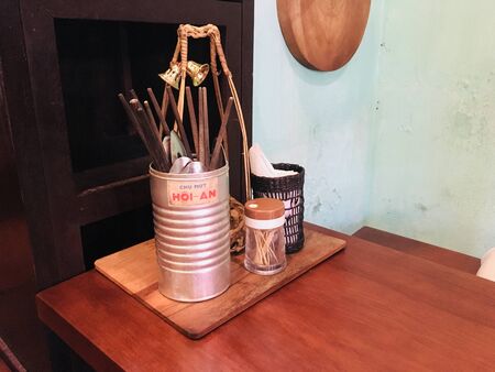 Chopsticks, spoon and other tool for meal on dining tableの写真素材