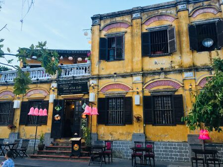 Mustard yellow culture building at Hoi An Ancient Town, Vietnam.のeditorial素材