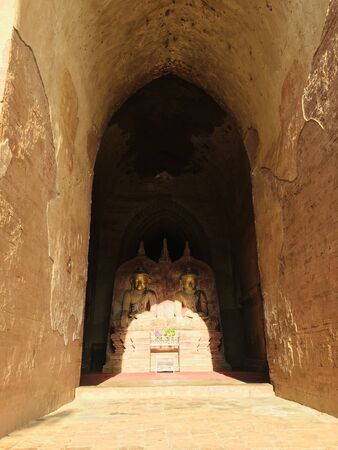 Buddha image in the shadow, statue and architecture Burmese fusion style at Dhammayangyi temple in Bagan city, Myanmarの写真素材