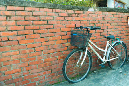 Bicycle beside brick wallの写真素材