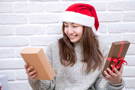 Smiling young woman with Christmas present box.の写真素材