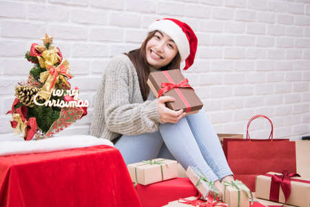 Smiling young woman with Christmas present box.の写真素材