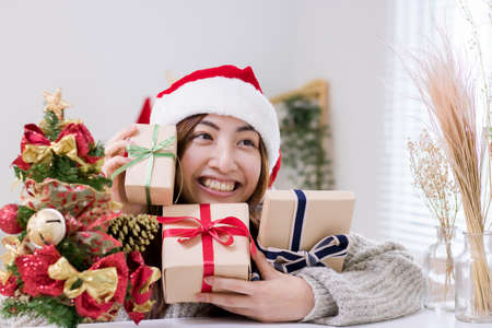 Smiling young woman and Christmas present box.の写真素材