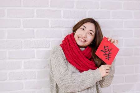 Beauty woman show spring festival couplets in chinese new year.の写真素材