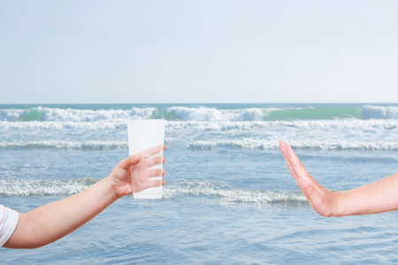 Refusing plastic bottle and straw concept (isolated on white background). No plastic. Global...