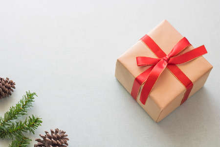 Christmas background with gift boxes, pine cone and decorations on light blue background....