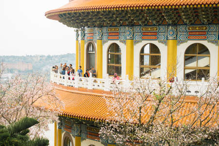 Tamsui Palace, Tamsui Town, New Taipei City-Apr 15 ,2019:  The crowd of tourists with sightseeing view of sakura cherry blossom  in Tianyuan Palace.のeditorial素材