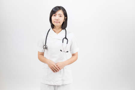 Young asian nurse with a stethoscope isolated over white background.の写真素材
