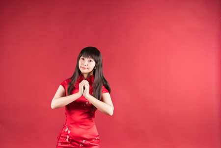 Woman in cheongsam with congratulation gestureの写真素材