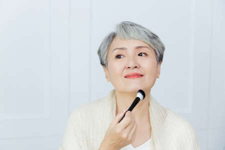 Asian senior woman suffer from cough with face mask protection